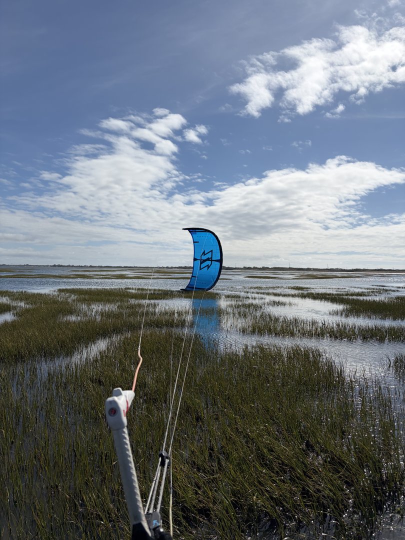 Kite view over flat Ervas water on an incoming tide
